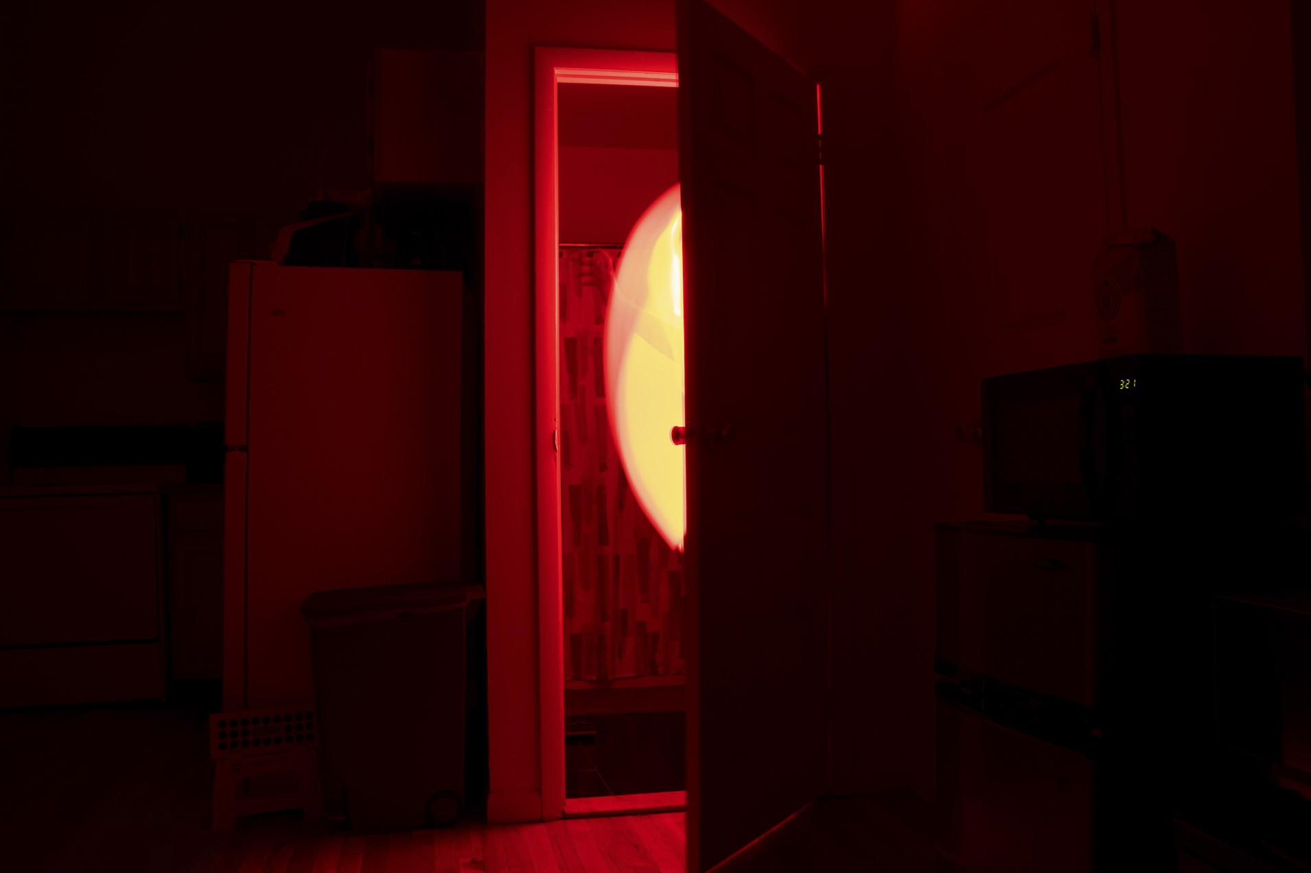 Light shines through an open door in a room
